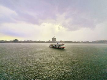 Ship sailing on sea against sky