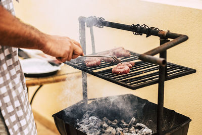 Man preparing food on barbecue grill