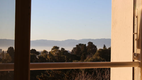 Scenic view of mountains seen through window