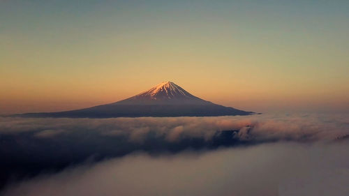 Scenic view of snowcapped fuji mountains against sky during sunset,japan