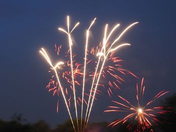 Sky illumed with fire crackers against clear blue sky