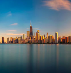 Illuminated buildings in city at waterfront