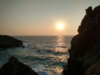 Scenic view of sea against clear sky during sunset