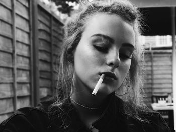 Close-up of young woman smoking cigarette