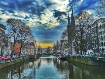 View of canal against cloudy sky