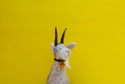 Close-up of stuffed toy against yellow background