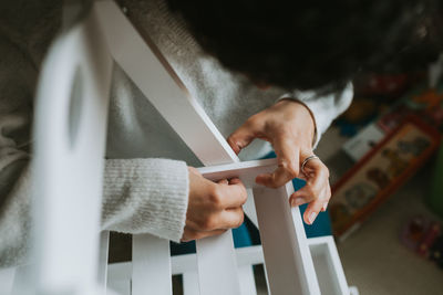 Woman fixing furniture at home