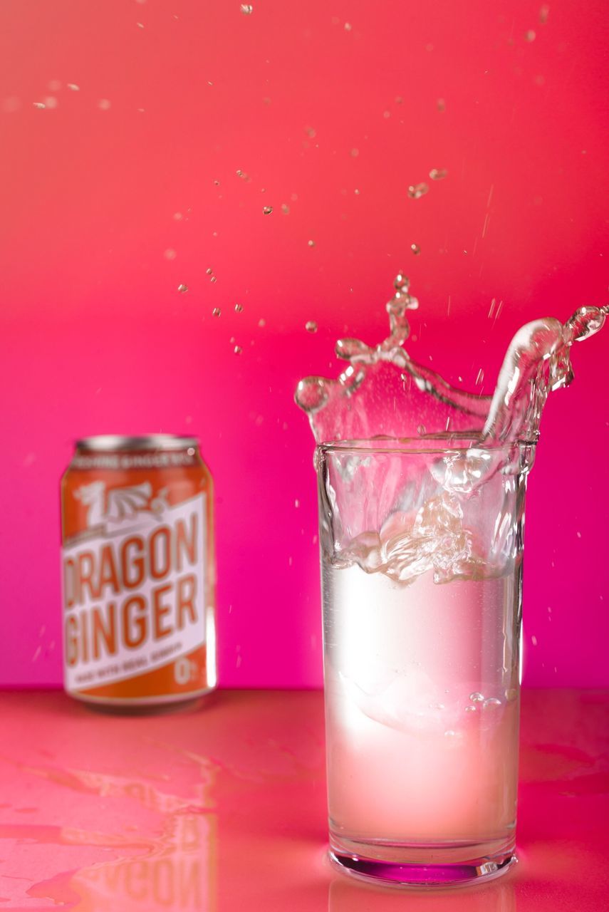 glass, household equipment, indoors, drinking glass, food and drink, studio shot, pink color, drink, table, transparent, glass - material, colored background, no people, refreshment, container, splashing, close-up, freshness, still life