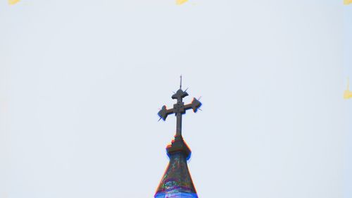Low angle view of cross against clear sky