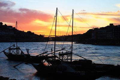 Boats in harbor at sunset