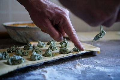 Midsection of person preparing food in kitchen