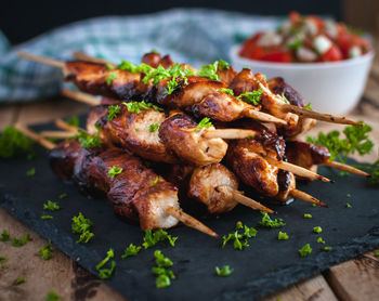 Close-up of homemade honey and beer bbq chicken skewers with fresh parsley