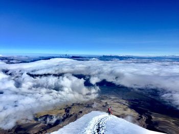 Scenic view of snowcapped mountains against blue sky