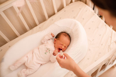 High angle view of baby boy sleeping on bed