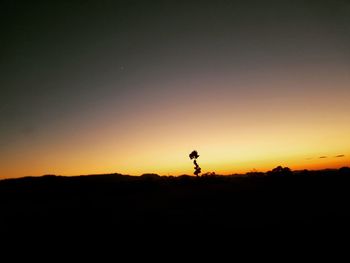 Silhouette landscape against sky during sunset