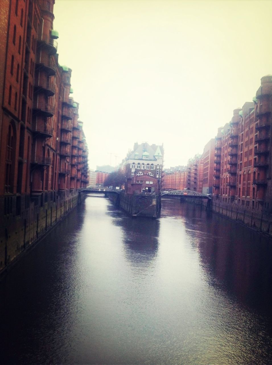 architecture, building exterior, built structure, canal, waterfront, water, city, clear sky, transportation, reflection, building, river, residential building, residential structure, sky, sunset, outdoors, mode of transport, copy space, diminishing perspective