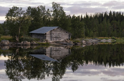 Reflection of trees in lake against sky