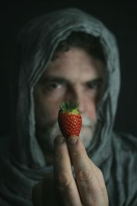 Close-up of man holding fruit