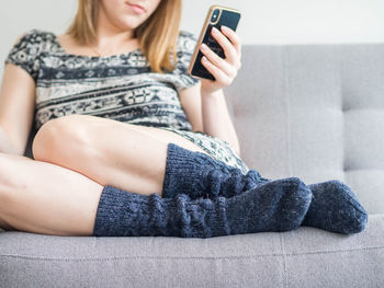 Midsection of woman using mobile phone