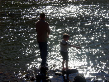 Full length of boy standing in water