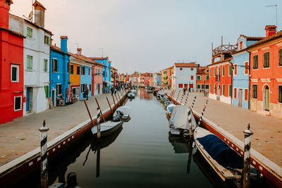 Picturesque canal street with tourists and colorful houses in burano