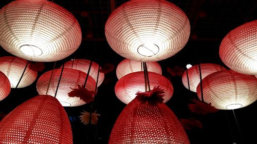 Low angle view of illuminated lanterns hanging at night