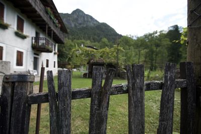 Wooden fence on field against mountains