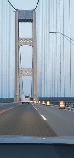 Bridge in city seen through car windshield