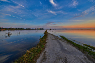 Scenic view of beach against sky during sunset