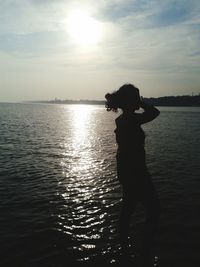 Man standing on sea against sky