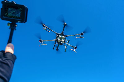 Agricultural drone in flight on a background of blue sky. field spraying new technologies.