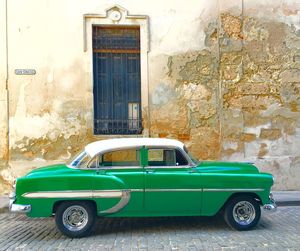 Vintage car parked against wall