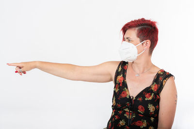 Portrait of man standing against white background