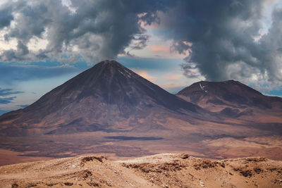 View of volcanic landscape against cloudy sky