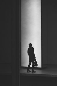 Full length of woman standing on wall