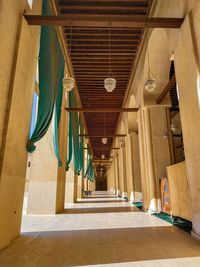 Low angle view of empty corridor of building