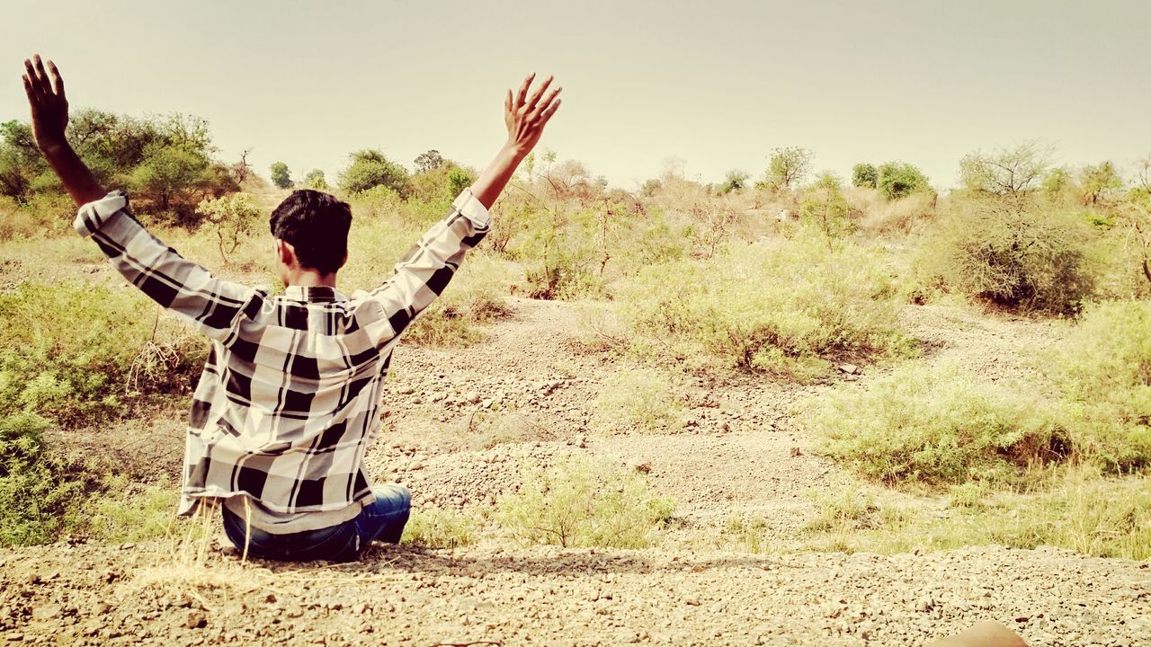 arms raised, real people, day, one person, outdoors, nature, clear sky, young adult, sky, people