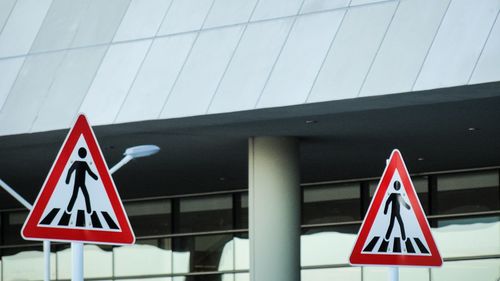 Low angle view of road sign against clear sky