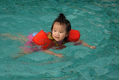 Portrait of cute boy in swimming pool