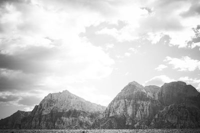 Scenic view of mountains against cloudy sky