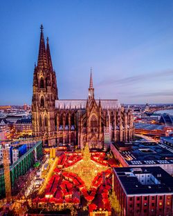 Cologne cathedral koln germany, illuminated buildings in city against clear sky at dusk