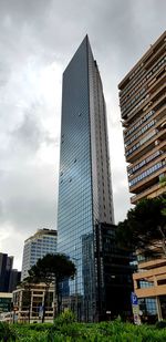 Low angle view of buildings against cloudy sky