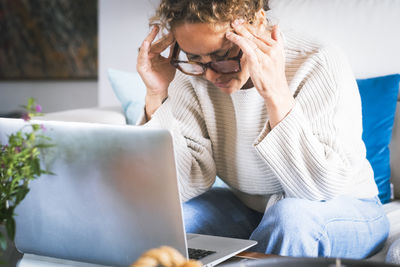 Young woman using laptop at home