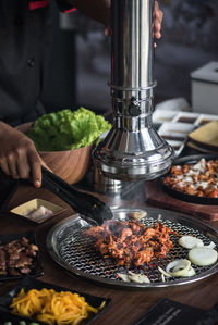 Person preparing food on table