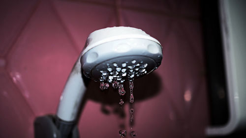 Close-up of hand shower in bathroom