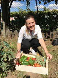 Portrait of smiling young woman against plants