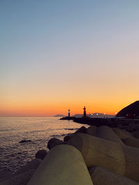 Scenic view of sea against clear sky during sunset