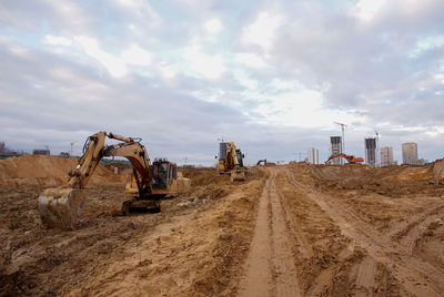 Group of the excavators for dig ground trenching at a construction site for foundation 