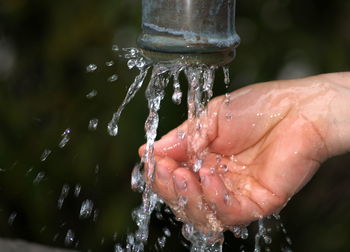Cropped image of person washing hand