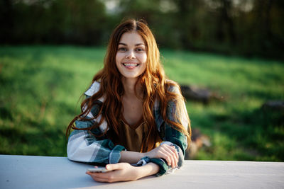 Portrait of young woman using mobile phone